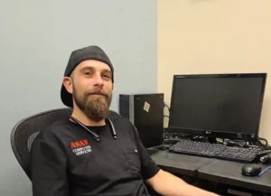 Josh, a local IT support technician from ASAP Computer Services sitting at a desktop workstation in San Antonio